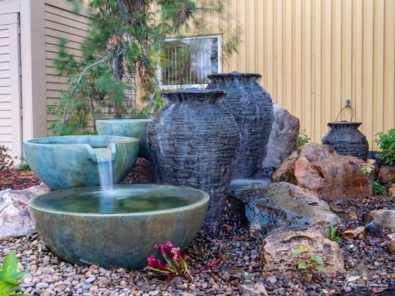Spillway bowls and a slate urn fountain set among boulders