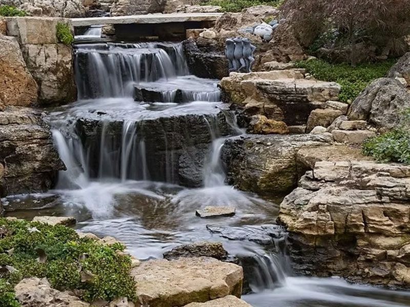 Multi-tiered waterfall tumbling over layered stone